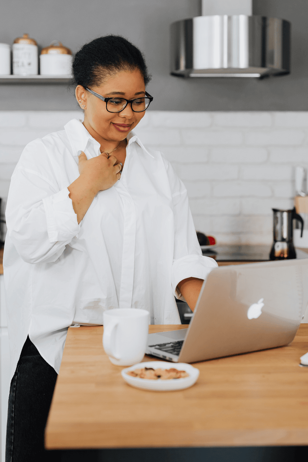 Woman working at a laptop in a kitchen